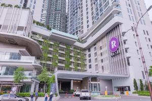 a building with a purple sign on the side of it at The Robertson Bukit Bintang by Wowhome in Kuala Lumpur