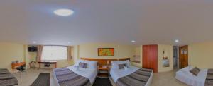 Postel nebo postele na pokoji v ubytování Hotel Estación Sabana