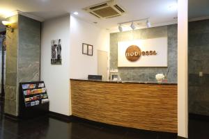 a lobby of a restaurant with a wooden counter at Noblesse Hotel in Jeju