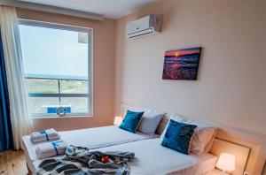 a bedroom with two beds and a window at Zornitsa Apart in Primorsko