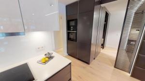 a kitchen with a white counter and a refrigerator at White Pearl Apartment 1.12 in Timmendorfer Strand