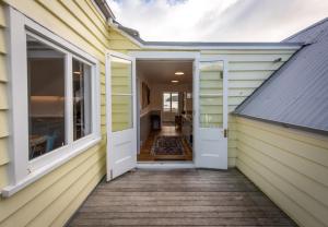 a hallway of a house with a white door at Akaroa Waterfront Apartment in Akaroa