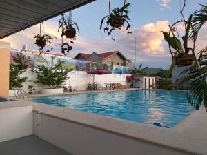 a large swimming pool in a house at Adams View Hotel in Moalboal