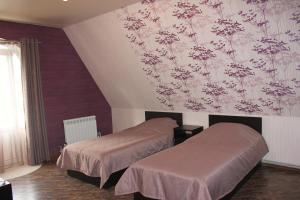 Cama o camas de una habitación en Zhara Hotel