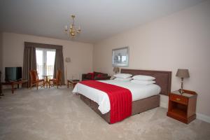 A bed or beds in a room at Links Country Park Hotel 