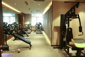 a gym with several tread machines in a room at Atour Hotel (Nantong Zhongcheng) in Nantong