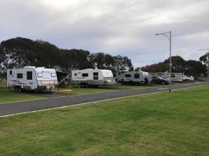 a group of rvs parked on the side of a road at BIG4 Bunbury Riverside Holiday Park in Eaton