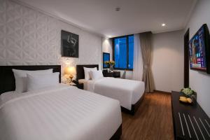 Postel nebo postele na pokoji v ubytování Hotel De La Seine