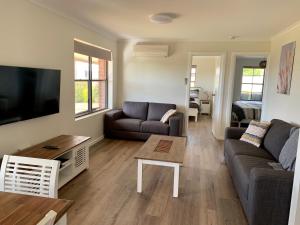 a living room with a couch and a coffee table at Berds Nest in Emu Bay