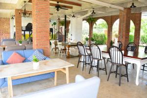a patio with chairs and tables and a couch at Home Ayutthaya in Phra Nakhon Si Ayutthaya +72 photos