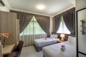Postel nebo postele na pokoji v ubytování Tanjung Puteri Golf and Resort Malaysia