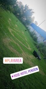 a green field with a sign on the grass at Rose Hotel B&B in Patara