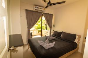 Postel nebo postele na pokoji v ubytování Aussieland Bungalows + 37 fotografií