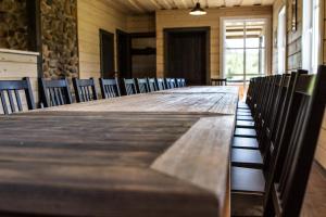a long table in a room with chairs at Alkūnų sodyba in Molėtai