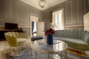 a living room with a couch and chairs and a table at PALAZZO FORLEO Luxury Apartment - TREB Collection in Lecce