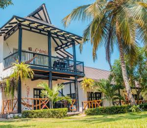 a building with a balcony and palm trees at Dreamer Palomino in Palomino