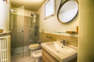 a bathroom with a sink and a toilet and a mirror at PALAZZO FORLEO Luxury Apartment - TREB Collection in Lecce +38 photos