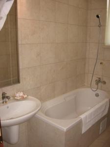 a bathroom with a sink and a bath tub next to a white sink at Verona Villas Complex in Mamaia Sat/Năvodari