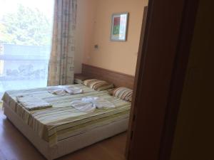a bedroom with a bed with towels on it at Апартамент с две спални в комплекс Лъки 2 Свети Влас in Sveti Vlas
