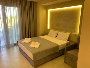 a hotel room with a bed with towels on it at Castella Apartments in Vourvourou +135 photos