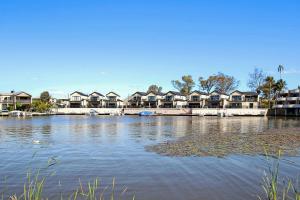 a large body of water with houses in the background at Cypress Townhouse 11 in Mulwala
