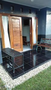 a living room with a couch and a table at Endah Homestay Syariah in Purwokerto