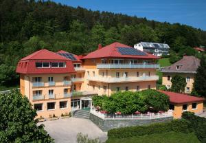 a building with solar panels on its roofs at Hotel Restaurant Marko in Velden am Wörthersee