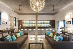 a living room filled with furniture and a large window at Blue Lime Phnom Penh in Phnom Penh