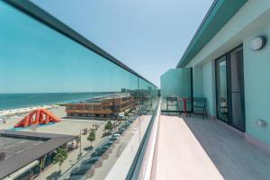 a view of the beach from a balcony of a building at ZIP Apartments in Mamaia