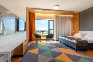 a hotel room with a bed and two chairs at Hotel Sophia by Tartuhotels in Tartu +38 photos