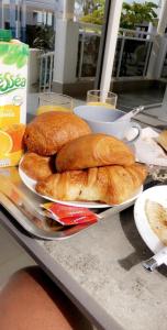 a table with a plate of bread on it at Bungalow Thaï vip jacuzzi interne in Ngaparou