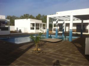 a house with a swimming pool and a building at Bungalow Thaï vip jacuzzi interne in Ngaparou +6 photos