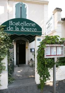 a building with a sign for a hospitalitute de la source at Hostellerie De La Source in Arles