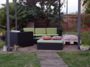 a gazebo with two couches and a table at Chambre Rose Blanche in Le Lude