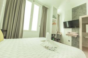 a bedroom with a large white bed with a large window at Hostal Pio Centro in Madrid