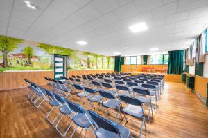 an empty lecture hall with blue chairs in it at LE SOUFFLE VERT in Cussac +21 photos