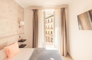 A bed or beds in a room at Hostal Pio Centro