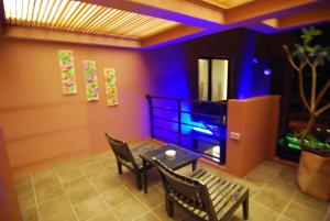 a dining room with a table and two chairs at A&L Inn 戀灣旅棧 in Nanwan