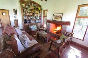 a living room with a fireplace and a couch at Ecoposada del Estero in Colonia Carlos Pellegrini