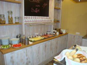 
a counter filled with lots of different types of food at StadtHotel Passau in Passau
