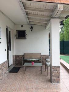 a patio with two benches on a brick patio at casa del sole Ossuccio in Como