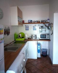 a small kitchen with a sink and a microwave at Marina House in Perast