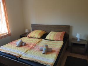 a bedroom with a bed with two pillows on it at Apartments Lean in Poreč