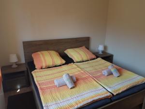 a bedroom with two beds with towels on them at Apartments Lean in Poreč