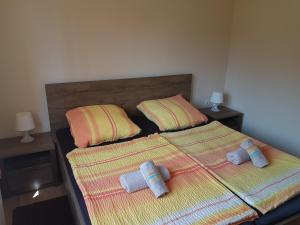 two beds in a bedroom with two pillows on them at Apartments Lean in Poreč