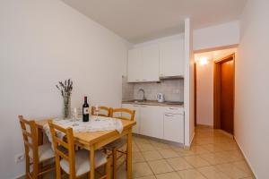 a kitchen and dining room with a table and chairs at Villa Milena in Trogir