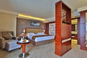 Postelja oz. postelje v sobi nastanitve Hôtel Huatian Chinagora