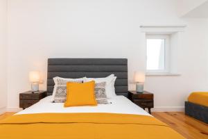 A bed or beds in a room at WHome | Combro Luxury Apartment