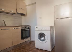 a kitchen with a washing machine and a refrigerator at La Bellavista Mola di Bari in Mola di Bari +19 photos