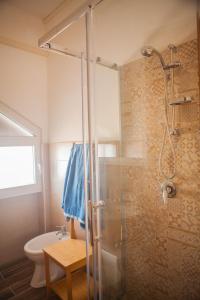 a bathroom with a shower and a toilet at La Bellavista Mola di Bari in Mola di Bari